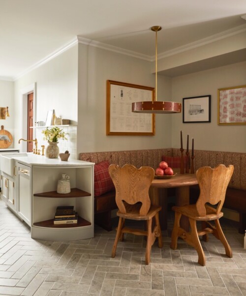 An Upper West Side Story A pair of mid-century oak dining chairs and a banquette surround a wood dining table, which provides a hub for the family to gather.