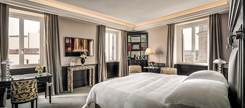 A junior suite bedroom at Hotel Hassler