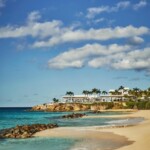 Explore Four Seasons Resort and Residences Anguilla, a beachfront haven featuring luxurious accommodations and vibrant tropical surroundings