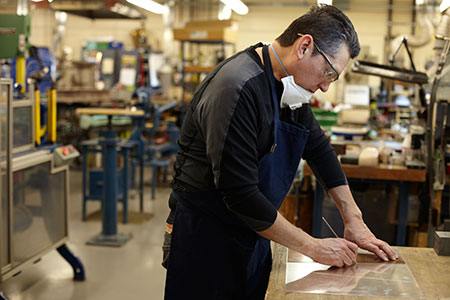 Silversmiths crafting the trophy